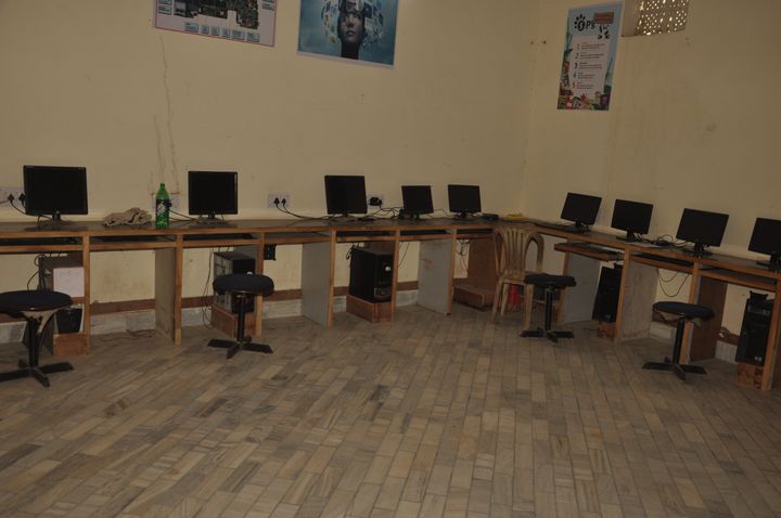 Computer laboratory with desktop computers arranged along the walls