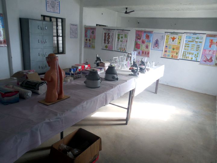 Zoology laboratory with an anatomical model, microscopes and biology charts